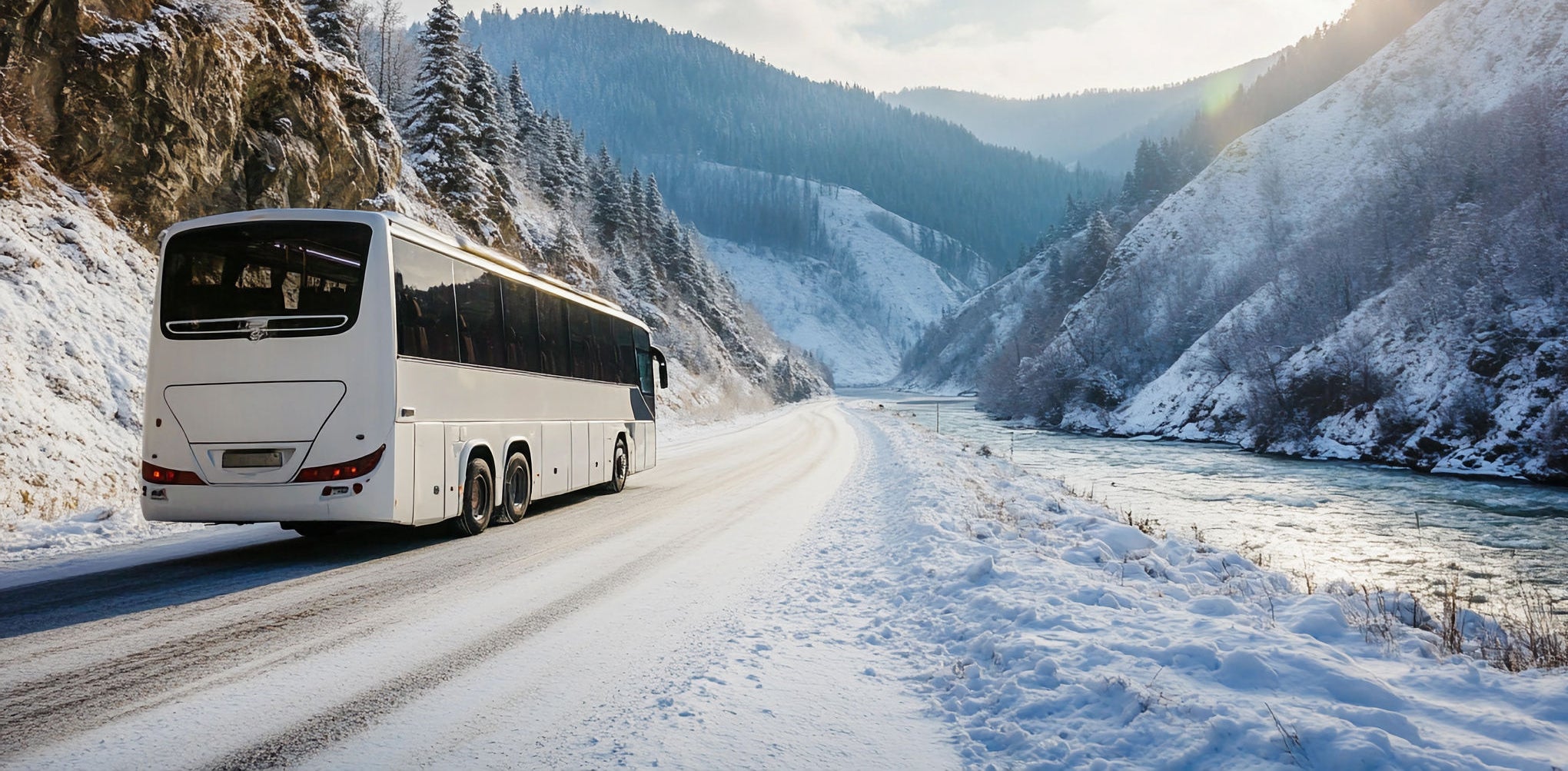 Winter bus journey along the river in snowy mountains