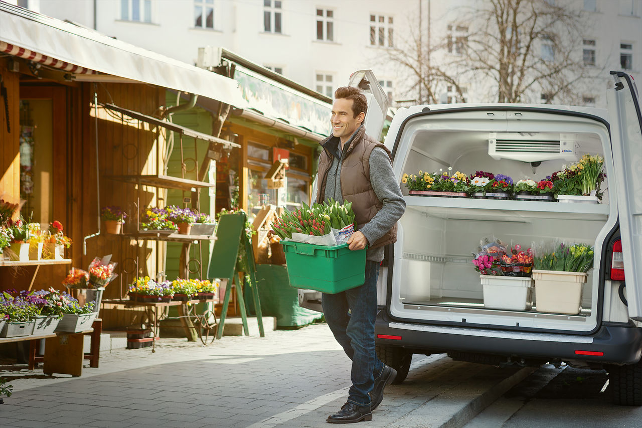 Urban last-mile refrigerated van with cargo cooling unit preserving flowers, illustrating Webasto as system partner for thermal management in deliveries.